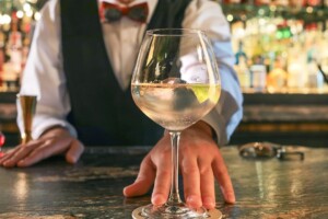 bartender serving a glass of win