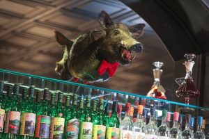 pig head with a bowtie above the bar